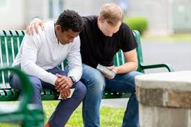 Two men praying together