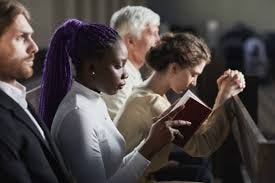 Diverse congregation praying together